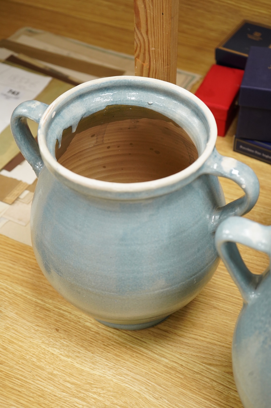 Seven early 20th century Continental blue glazed terracotta twin handled jars, 26cm high